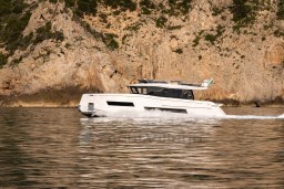 2025 Pardo Yachts Endurance 72 cruising near rocky coastline.
