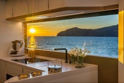 Modern kitchen on Pardo Yachts Endurance 72, 2025, with ocean sunset view.
