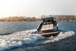 2026 Pardo Yachts 43 cruising on a serene lake with scenic background.