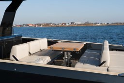 Luxurious seating area on 2026 Pardo Yachts 43, with scenic waterfront view.