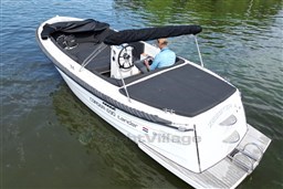 Corsiva 690 Tender boat from 2012 on calm water, featuring sleek design and comfortable seating.