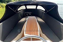 Corsiva 690 Tender 2012 boat interior with wooden deck and cushioned seating.