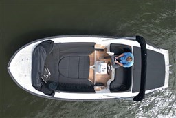Overhead view of 2012 Corsiva 690 Tender boat with person steering on calm water.