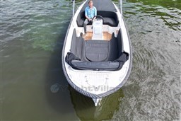 Corsiva 690 Tender 2012 boat on water, featuring spacious seating and sleek design.