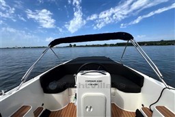 Corsiva 690 Tender boat, 2012 model, on calm water under a blue sky.