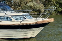 2008 INTER 9000 Sportivo boat on water, featuring sleek design and chrome railings.