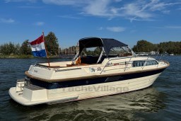 2008 INTER 9000 Sportivo boat on water with Dutch flag, clear sky background.