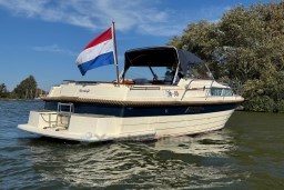 2008 INTER 9000 Sportivo boat on water with Dutch flag, clear sky background.