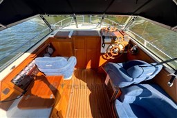 Interior of 2008 INTER 9000 Sportivo boat with wooden accents and blue seating.