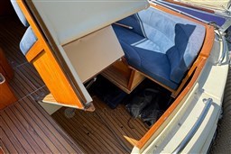 Interior of 2008 INTER 9000 Sportivo boat with wooden flooring and blue seating.