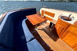 Luxurious 2008 INTER 9000 Sportivo boat interior with wooden deck and blue seating.