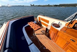 Luxurious 2008 INTER 9000 Sportivo boat interior with wooden deck and blue seating on a sunny day.