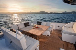Luxurious 2025 Pardo Yachts GT 52 deck with elegant seating and ocean view at sunset.