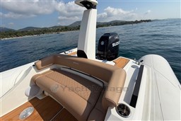 2026 Brig Eagle 8 boat with Suzuki engine on calm waters, featuring luxurious seating.