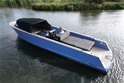 Isloep Rapida 990 boat, 2010 model, cruising on a calm river with lush greenery.