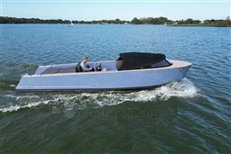 Isloep Rapida 990 boat cruising on a lake, 2010 model, with a person steering.