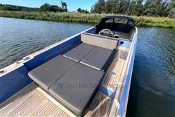 Isloep Rapida 990 boat, 2010 model, with sleek design and spacious deck on calm water.
