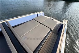 Isloep Rapida 990 boat deck with cushioned seating, 2010 model, on calm water.