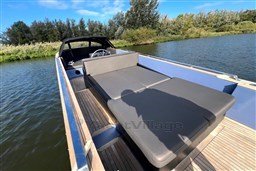 2010 Isloep Rapida 990 boat with sleek deck and comfortable seating on a serene waterway.
