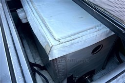 Storage compartment in a 2010 Isloep Rapida 990 boat, featuring a covered box.