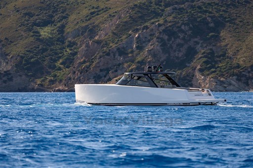 Luxury VanDutch 75 yacht cruising near rocky coastline, 2025 model.