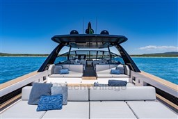 Luxurious 2025 VanDutch 75 yacht with spacious deck and plush seating on open water.