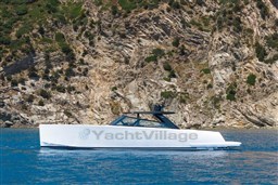 2025 VanDutch 75 yacht cruising near rocky coastline, showcasing sleek design and luxury.