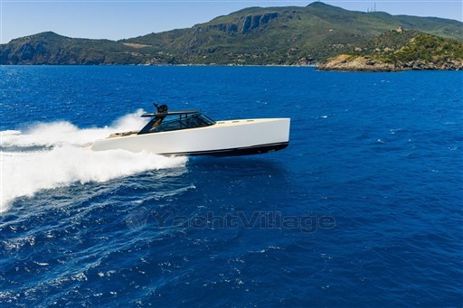 VanDutch 75 yacht cruising in blue ocean near scenic coastline, 2025 model.
