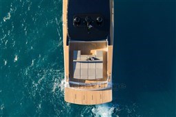 Aerial view of 2025 VanDutch 75 yacht cruising on blue ocean waters.