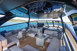 Luxurious 2025 VanDutch 75 yacht interior with elegant seating and scenic ocean view.