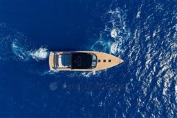 Aerial view of 2025 VanDutch 75 yacht cruising on deep blue ocean waters.