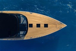 Aerial view of 2025 VanDutch 75 yacht on blue ocean water.