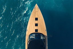 Aerial view of 2025 VanDutch 75 yacht on blue ocean water.