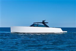 2025 VanDutch 75 yacht cruising on open sea under clear blue sky.