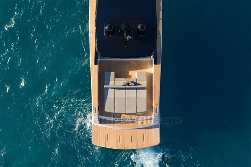 Aerial view of 2025 VanDutch 75 yacht cruising on blue ocean waters.