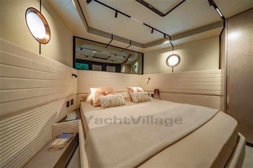 Luxurious bedroom interior of 2025 VanDutch 75 yacht with modern design and cozy bedding.