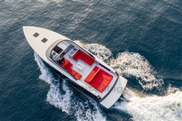 2025 VanDutch 48 yacht cruising on open water with red seating.