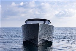 2025 VanDutch 48 yacht on calm sea under cloudy sky.