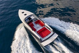 VanDutch 48 yacht cruising on open water, 2025 model, with sleek design and red seating.