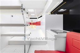 Luxurious interior of 2025 VanDutch 48 yacht with modern design and red seating.