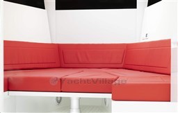 Red cushioned seating in 2025 VanDutch 48 yacht interior.