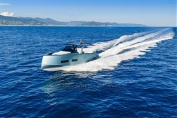 2026 Pardo Yachts 43 cruising on open sea with scenic mountain backdrop.