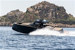 2025 Pardo Yachts 50 cruising near rocky island, sleek design, luxury yacht.