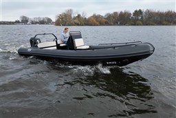 2021 Infanta 750 boat cruising on a lake with a person onboard.