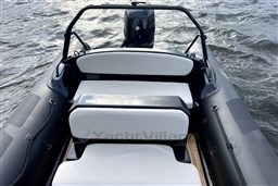 2021 Infanta 750 boat with white seating on water.