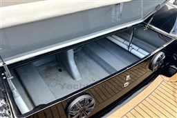 Open storage compartment of 2021 Infanta 750 boat with speakers and pipes visible.