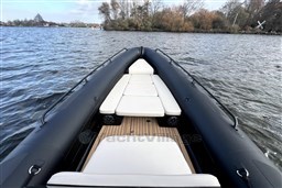 Inflatable boat Infanta 750, 2021 model, on a serene lake with cushioned seating.