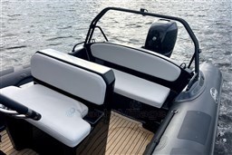 2021 Infanta 750 boat interior with white seating, black accents, and visible outboard motor.