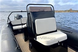 2021 Infanta 750 boat with sleek design, comfortable seating, and scenic water backdrop.