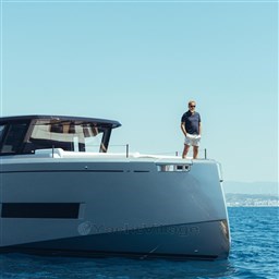2025 Pardo Yachts GT75 with person on deck, cruising in clear blue waters.